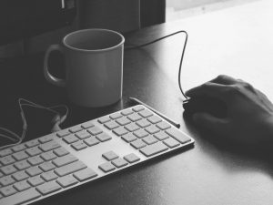 computer keyboard, mouse, and coffee